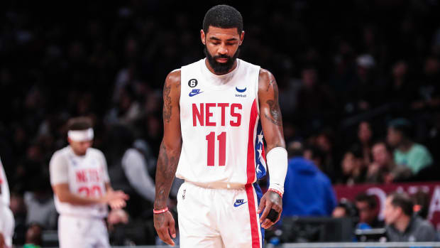 Kyrie Irving looks down on court.